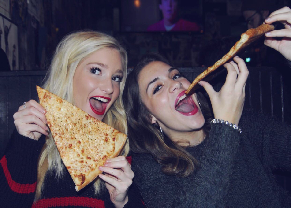 Two ladies enjoying pizza